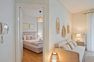 a living room with a couch and a bed at Modern Beach Retreat 2BR in Coastal Palaio Faliro in Athens