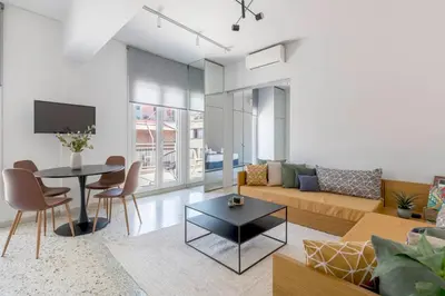 a living room with a couch and a table at The HostMaster StreetMuse in Athens