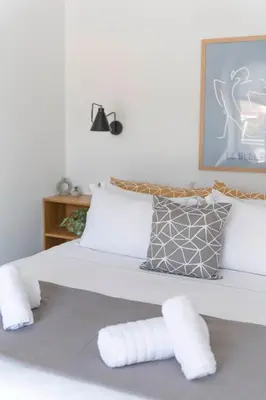 a bedroom with a bed with white sheets and pillows at The HostMaster StreetMuse in Athens