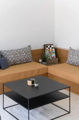 a living room with two beds and a coffee table at The HostMaster StreetMuse in Athens