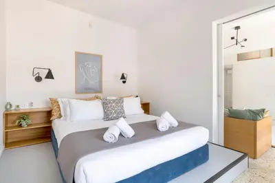 a bedroom with a large bed with white pillows at The HostMaster StreetMuse in Athens