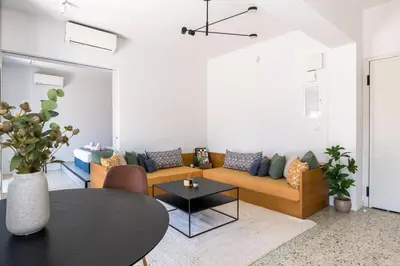 a living room with a couch and a table at The HostMaster StreetMuse in Athens