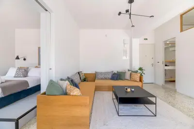 a living room with a couch and a bed at The HostMaster StreetMuse in Athens
