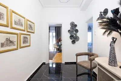 a living room with a chair and a table at Supreme Aprt Syntagma Kolonaki in Athens