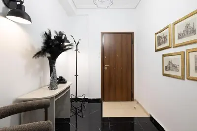 a hallway with a door and a table with a plant at Supreme Aprt Syntagma Kolonaki in Athens