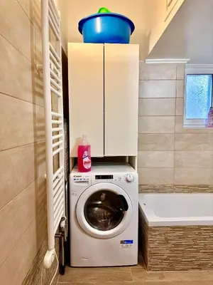 a washing machine with a blue bowl on top of it at Smirni Snug Stay Garden Fits 4 in Athens