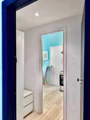 a hallway with a door leading into a room at Smirni Snug Stay Garden Fits 4 in Athens