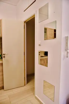 a room with a door and a mirror at Smirni Snug Stay Garden Fits 4 in Athens