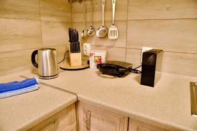 a kitchen counter with a counter top with a toaster at Smirni Snug Stay Garden Fits 4 in Athens