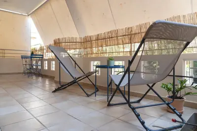 two chairs and a table in a room with windows at 42sqm - Private Parking - Central - Big Balcony Luma in Athens
