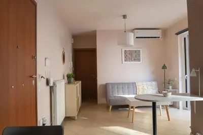 a kitchen and a living room with a table and a couch at 42sqm - Private Parking - Central - Big Balcony Luma in Athens