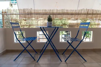 two chairs and a table with a potted plant on it at 42sqm - Private Parking - Central - Big Balcony Luma in Athens