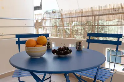 a blue table with a bowl of fruit on it at 42sqm - Private Parking - Central - Big Balcony Luma in Athens