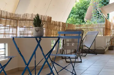 a blue table and chairs on a patio at 42sqm - Private Parking - Central - Big Balcony Luma in Athens