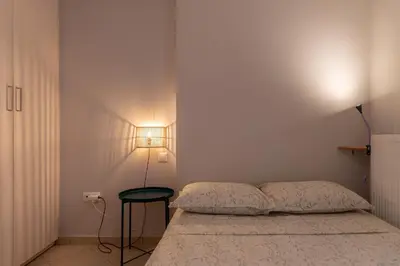 a bedroom with a bed and a side table at 42sqm - Private Parking - Central - Big Balcony Luma in Athens