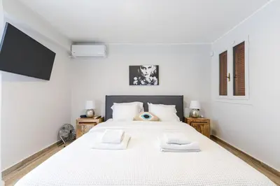 a bedroom with a white bed with two towels on it at Modern apartment in Glifada in Athens