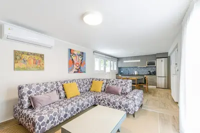 a living room with a couch and a kitchen at Modern apartment in Glifada in Athens