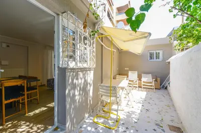 a balcony with a table and chairs in a house at Modern apartment in Glifada in Athens