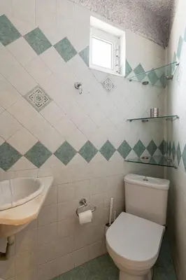 a bathroom with a toilet and a sink at Red Arena View in Piraeus