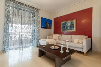 a living room with a couch and a coffee table at Red Arena View in Piraeus