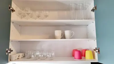 a cupboard filled with glasses and wine glasses at Palaio Faliro Breeze in Athens