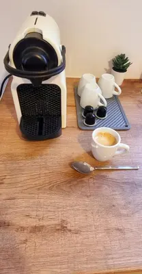 a coffee maker sitting on top of a wooden table at Palaio Faliro Breeze in Athens