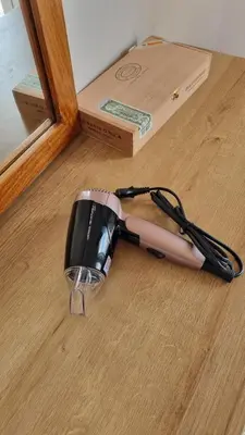 a hair dryer on the floor next to a box at Palaio Faliro Breeze in Athens