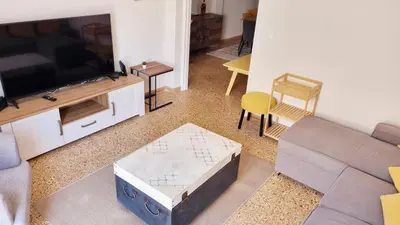 a living room with a couch and a tv at Palaio Faliro Breeze in Athens