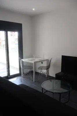 a living room with a white table and chairs at Athenean Porto Pireaus Suites-B1 in Piraeus