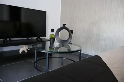 a glass table with a mirror and a tv at Athenean Porto Pireaus Suites-B1 in Piraeus