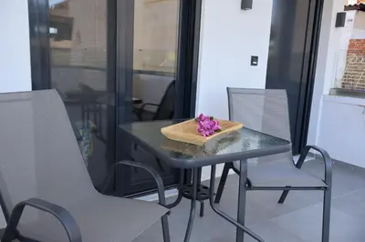 a table with a bowl of flowers on top of it at Athenean Porto Pireaus Suites-B1 in Piraeus
