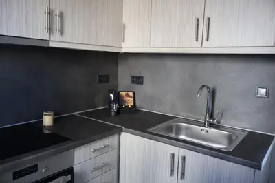 a kitchen with a sink and white cabinets at Athenean Porto Pireaus Suites-B1 in Piraeus