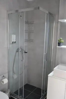 a shower with a glass door in a bathroom at Athenean Porto Pireaus Suites-B1 in Piraeus