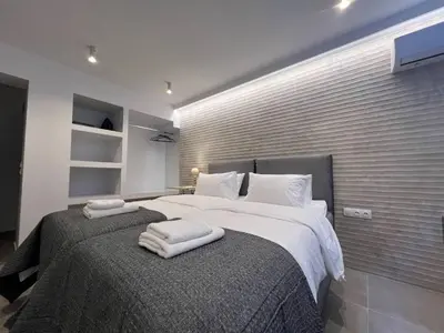 a bedroom with a large bed with towels on it at MetroSide & Concert Hall Studio by ΜΡS in Athens