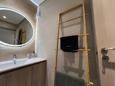 a bathroom with a sink and a mirror at MetroSide & Concert Hall Studio by ΜΡS in Athens