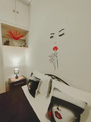 a bedroom with a bed with a picture of a woman at Old area of Athens in Athens