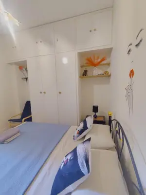 a bedroom with a bed and white cabinets at Old area of Athens in Athens