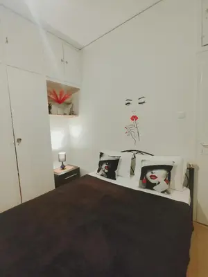 a bedroom with a large bed with white walls at Old area of Athens in Athens