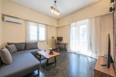 a living room with a couch and a table at Eudoxus Haus in Athens