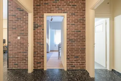a brick wall in a room with a doorway at Eudoxus Haus in Athens