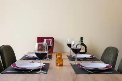 a wooden table with glasses of wine on it at Pagrati Sunlit Penthouse in Athens