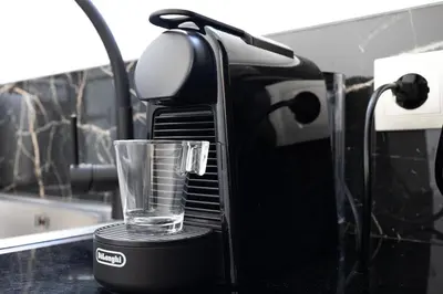 a glass sitting on top of a coffee maker at Pagrati Sunlit Penthouse in Athens