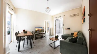 a living room with a couch and a table at Pagrati Sunlit Penthouse in Athens