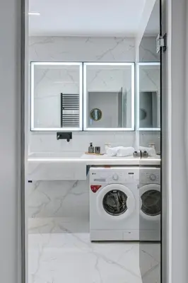 a white kitchen with a washing machine and a sink at Staiko Apartment in Athens