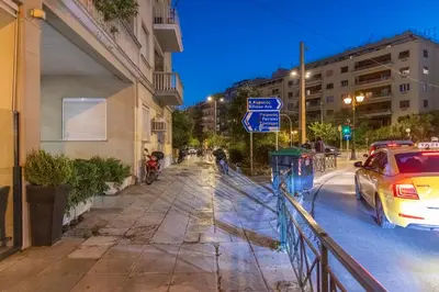 a street at night with a car parked on the street at Staiko Apartment in Athens