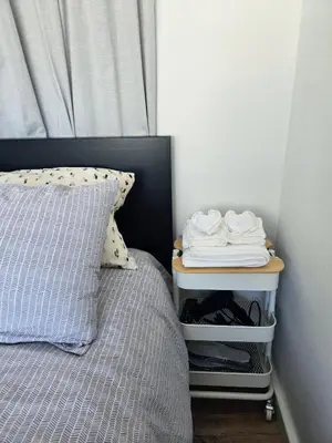 a bed with a night stand next to a bed with a pillow at Acropolis View Sky Suite with Jacuzzi near Metro in Athens
