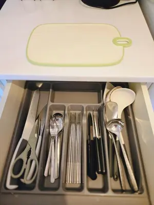 a drawer filled with silver utensils in a drawer at Acropolis View Sky Suite with Jacuzzi near Metro in Athens
