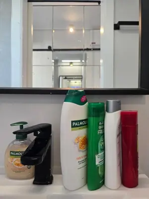 a kitchen counter with bottles of cleaning products on it at Acropolis View Sky Suite with Jacuzzi near Metro in Athens