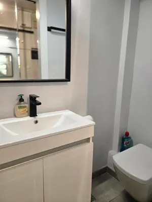 a bathroom with a sink and a toilet and a mirror at Acropolis View Sky Suite with Jacuzzi near Metro in Athens
