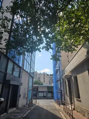 an empty street with a blue door on a building at Acropolis View Sky Suite with Jacuzzi near Metro in Athens